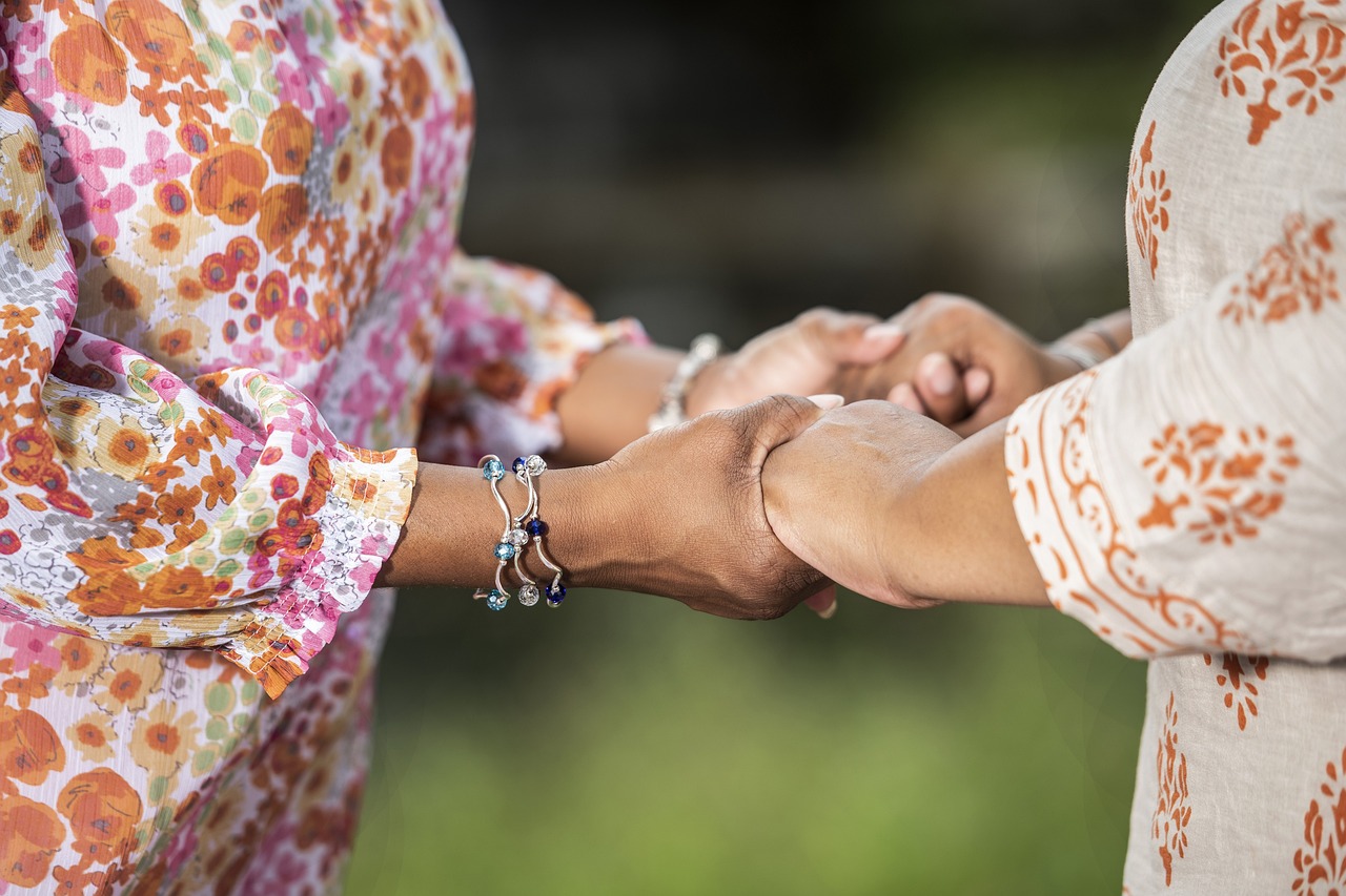 women clasping hands